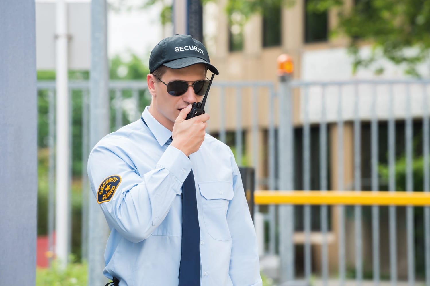 Security Guard Talking On Walkie-talkie